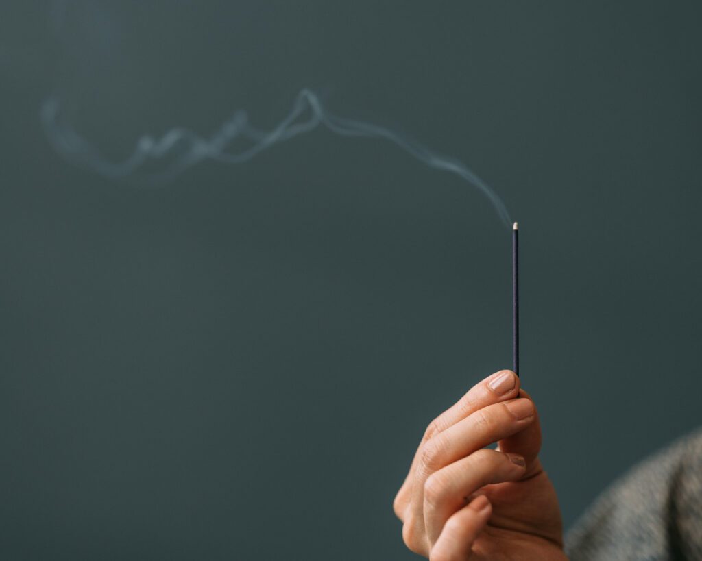 a person holding an incense